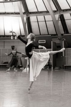 a ballerina is practicing her moves on the dance floor