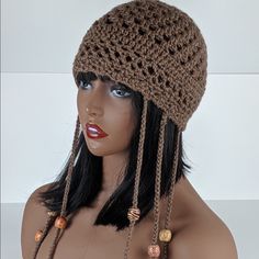 a mannequin head wearing a brown crochet hat with beads on it