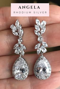 These are dainty, feminine cascading cubic zirconia teardrop wedding earrings. Chandelier earrings perfect as a part of the bridal jewelry or wedding jewelry. These are statement earrings but delicate and elegant. We apply high quality diamond simulant (cubic zirconia) that will make you shine even more in your special day, absolutely goes with everything! Rhodium silver plated metal. All earrings features high quality electroplating that does not fade or chip. I am sure you will continue to enj Glamorous Teardrop Diamond Earrings For Wedding, Glamorous Drop Chandelier Earrings For Anniversary, Elegant Pear-shaped Diamond Earrings For Wedding, Wedding Dangle Diamond Earrings, Elegant Pear-shaped Chandelier Earrings For Party, Glamorous Cubic Zirconia Drop Chandelier Earrings, Rose Gold Cubic Zirconia Drop Bridal Earrings, Glamorous Teardrop Bridal Earrings With Elegant Design, Elegant Teardrop Chandelier Earrings For Anniversary