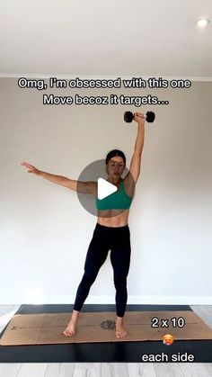 a woman standing on top of a yoga mat holding two dumbbells