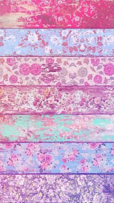 an old wooden plank with flowers painted on it in different colors and sizes, as well as the background