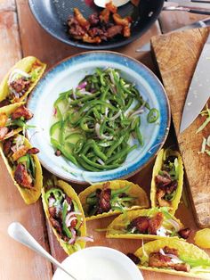 some tacos and other food on a table