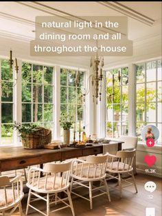 the dining room table is surrounded by white chairs and large windows with lots of natural light