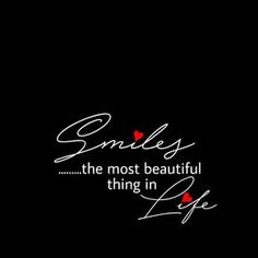 the words smile, the most beautiful thing in life written on a black background with red hearts