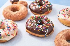 six donuts with chocolate frosting and sprinkles