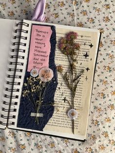 an open book with flowers on it