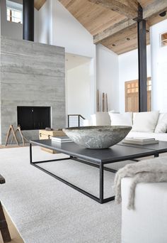 a living room filled with furniture and a fire place next to a wall mounted tv