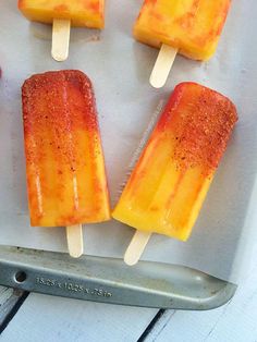 four popsicles are sitting on a baking sheet and ready to be cooked in the oven