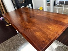 a large wooden table sitting on top of a hard wood floor