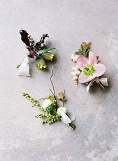 three boutonniers with flowers on the ground