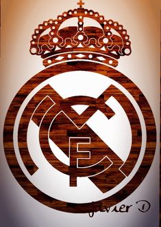 the real madrid crest is made out of wood and has a crown on top of it