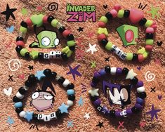 Kandi based on Invader Zim! Zim, Gir, Dib Membrane, and Gaz Membrane, as well as any other custom character!! PLUR (*'ω'*) Some of my kandi is one of a kind, as I recycle some beads from bracelets I purchase 2nd hand. I will probably redesign each bracelet as I run out of beads. Yours may look a little different than the pictures but will use the same colors! Order these as they are, or feel free to message about changing or adding colors/beads. Also feel free to DM about customs! Kandi is stretchy & will fit most wrists, please specify the size you'd like if needed. Beads On Safety Pins, Kandi Invader Zim, Gir Bracelet Kandi, Sanrio Kandi Bracelets, Scenecore Bracelets, Invader Zim Bracelet, Gir Kandi Cuff Pattern, Scene Bracelets Kandi, Scene Kid Bracelets