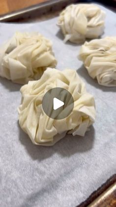 some dumplings are sitting on a baking sheet