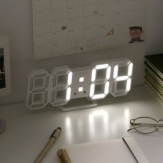 an alarm clock sitting on top of a desk