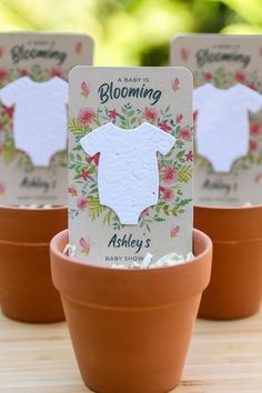 baby is blooming card in a flower pot