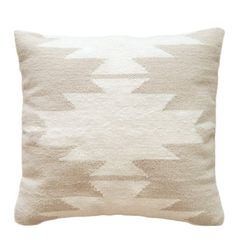 a beige and white pillow on a white background