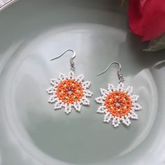 White daisies Earrings with daisies - GREAT  Make your day more colorful with some of my items. Each of them is handmade with a lot of love and positive energy. Great bead earrings. Margarita earrings in white and orange. Stunning earrings with white flowers. These unique earrings are the perfect addition to any of your looks. A gift for you or your loved one, a gift for an anniversary, birthday or wedding. The earrings are 5 cm long, 3.5 cm long and 3.5 cm wide. You can choose between a clip or wire for the ears. Depending on where you view the item on a mobile device or monitor, the colors may have a slight mismatch. If you have questions or ideas, do not hesitate to ask them. Thank you for visiting my store! For more great jewelry you can visit this link  https://www.etsy.com/shop/Natal Margarita Earrings, Daisies Earrings, White And Orange Flowers, Daisy Beads, Flowers Hanging, Red String Bracelet, White Daisies, Beads Earrings, White And Orange