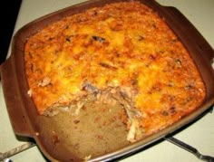 a casserole dish with meat and cheese on it