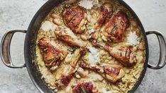 a pan filled with chicken and rice on top of a table