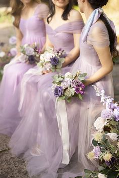 two bridesmaids in lavender dresses with flowers on their bouquets and the words save up to $ 200