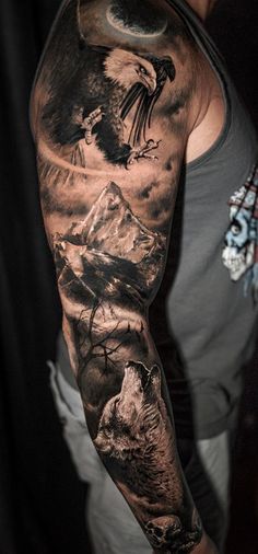 a man's arm with an eagle and mountain scene tattoo on the left sleeve