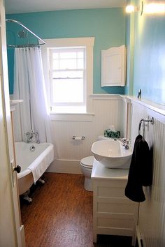 a bathroom with blue walls and white fixtures