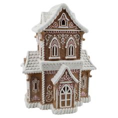 a brown and white gingerbread house ornament on a white background with snow