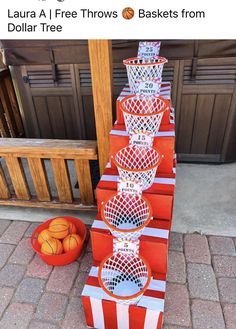 basketballs are stacked on top of each other in front of an orange and white striped box