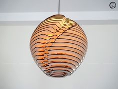 a circular light fixture hanging from the ceiling in a room with white walls and flooring