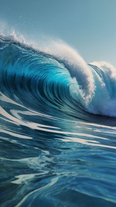 a large blue wave in the ocean on a sunny day