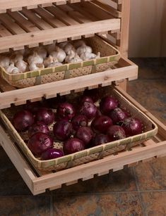 two wooden crates filled with onions and mushrooms