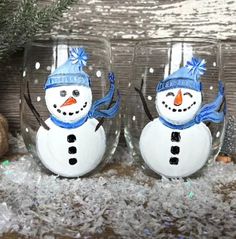 two wine glasses with snowmen painted on them