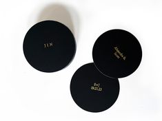 three round black coasters with gold lettering on the sides, one for japan and one for japan