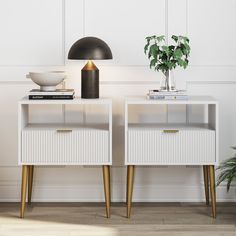 two white nightstands side by side with plants and books on the top, against a white wall