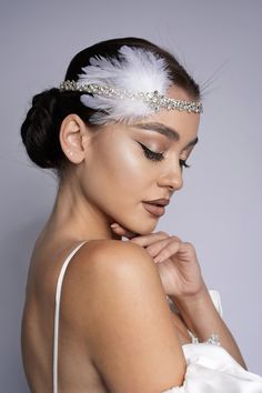 Amazing flapper Headpiece is rhinestone headband with white feather is a gorgeous accessory for your special occasions such as photo shoots, Great Gatsby Wedding or party, Engagement, Birthdays, graduation, Bridal shower or for you to dress up on any ordinary day! All beads are individually sawed in by me with love and care! Regulated by ribbon Can be tied around the neck and head READY TO SHIP. * All items are gift boxed and your order will be carefully packed in branded box, so that the product is fixed in the box and not bruised. ------------------------------ ✅Real colours may slightly different from one monitor to another,as it depends on. Specific monitor settings. ✅The products will be shipped by courier company and the trucking number will be sent to the customers. ✅Created in a pe Flapper Dress Headband, Great Gatsby Hair Piece, White Gatsby Outfit, Feather Headpiece Wedding, Great Gatsby Headpiece Diy, White Feather Headpiece, Gatsby Headpiece Diy, Great Gatsby Party Hairstyles, Gatsby Party Makeup