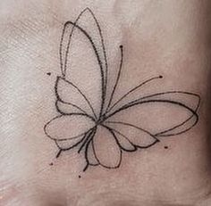 a small butterfly tattoo on the wrist