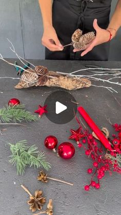 a person is making christmas decorations with pine cones