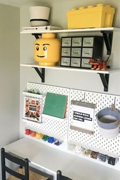 a white desk topped with lots of shelves filled with books and other items on top of it