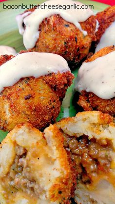 some fried food on a green plate with sauce drizzled over the top