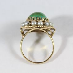 -Vintage 14k Gold Natural Turquoise and Pearl Ring 7.25US -Ring size: 7.25US -Turquoise size: 14 mm x 11.5 mm -Pearl size:about 3 mm -Total weight: 7 g -Marked 14k Vintage Yellow Gold Oval Turquoise Ring, Vintage Yellow Gold Turquoise Cabochon Ring, Vintage Yellow Gold Turquoise Oval Ring, Antique Turquoise Ring In Yellow Gold, Antique Yellow Gold Turquoise Cabochon Ring, Vintage Multi-stone Green Emerald Ring, Vintage Green Emerald Ring With Multi-stone, Vintage Yellow Gold Turquoise Ring For Formal Occasions, Vintage Multi-stone Oval Cabochon Rings