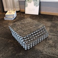 a box that is sitting on the floor in front of a book and some books