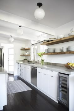 the kitchen is clean and ready to be used for cooking or baking, with white cabinets and stainless steel appliances