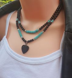 Natural gemstone blue turquoise & matte black onyx beaded layered necklace, with black enamel heart pendant adjustable back lobster claw clasp + extension chain. Set of 2 pieces. Material: -Natural gemstone - blue turquoise (6mm x 2 mm), matte black onyx (6mm). Pendant: zinc alloy enamel heart pendant (23mm x 23mm"  (lead & nickel free) - black stainless steel back lobster claw clasp & extension chain) - metal - antique silver spacers Necklace length: Layer 1 - 17.25" long ( includes 2" extension chain) Layer 2 - 18" long (includes 2" extension chain) ------------- SHIPPING ◊ Get your orders FAST! Our processing time is only 1-2 business days for most orders.  ------------------- JEWELRY PACKAGING ◊ This listing comes packaged in our high quality cardboard jewelry box with silver glitter c Black Double Strand Bohemian Jewelry, Black Adjustable Double Strand Jewelry, Handmade Black Necklace For Layering, Black Handmade Necklace For Layering, Black Double Strand Bohemian Necklace, Black Bohemian Double Strand Necklace, Black Multi-strand Layering Jewelry, Handmade Adjustable Black Turquoise Necklace, Black Heart Beads For Jewelry Making