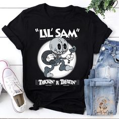 a black shirt with the words lil sam on it and an image of a cartoon character holding