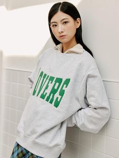 This sweatshirt features a relaxed fit with a ribbed crew neck, cuffs, and hem, ensuring comfort and a casual style. Emblazoned across the front is the word LOVERS in bold, collegiate-style lettering, making a strong statement. The typography is outlined, giving it dimension and a pop of detail against the sweatshirt's base. This piece is likely to appeal to those looking to make a romantic or affectionate statement through their clothing.- The bold lettering of LOVERS adds a playful and expressive element to the sweatshirt.- The sweatshirt's classic cut provides a versatile base for the eye-catching graphic.- It's a piece that combines the comfort of loungewear with a graphic that's designed to be seen and make a statement. Relaxed Fit Crew Sweatshirt For Campus, Oversized Sweater With Ribbed Cuffs For Campus, Collegiate Oversized Sweats With Ribbed Cuffs, Oversized Collegiate Sweats With Ribbed Cuffs, Relaxed Fit Crew Sweater For Campus, Varsity Sweatshirt With Text Print, Oversized College Sweatshirt With Ribbed Collar, Oversized Sweatshirt With Ribbed Collar For College, Oversized Sweatshirt For College