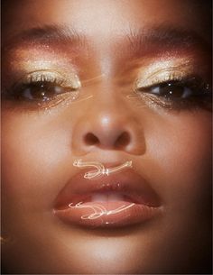 a woman's face with gold makeup