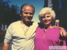 an older man and woman standing next to each other