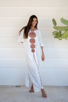 This beautiful free size Kaftan has a unique presence to it. It's colorful and most importantly comfortable wear, light and soft and can be used on many occasions -  home gatherings, dinners, or just in your home to feel comfortable.  Fabric : 80% Egyptian Cotton and 20% Polyester Measurements : Free size. Fits up to 4XL. Also there is a belt that can be used to tighten the dress around the hips.  Bust size : 78 inches Length : 145 inches For reference the model is a size 4 US and 5'8". As you c White V-neck Kaftan For Spring, Bohemian White V-neck Cover-up, Bohemian Embroidered Cover-up, Traditional White V-neck Maxi Dress, White Free Size Maxi Dress For Beach Cover-up, Spring Bohemian Embroidered Kaftan, Spring Embroidered Bohemian Kaftan, White V-neck Embroidered Dress For Festival, Bohemian White Cover-up For Festival