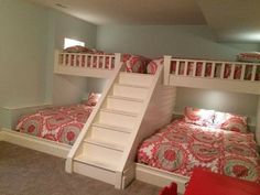 two bunk beds with stairs to the top and bottom, in a room with carpeted flooring