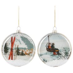 two christmas ornaments hanging from chains on a white background